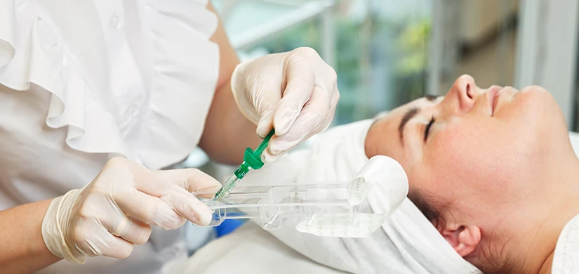 A clinician preparing an injectable treatment
